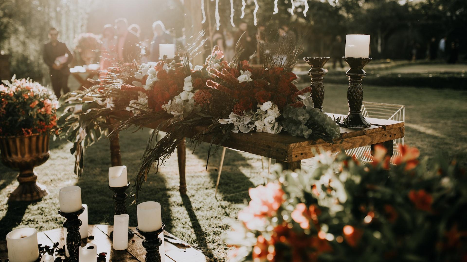 assorted-color flower decors on table with candle holders